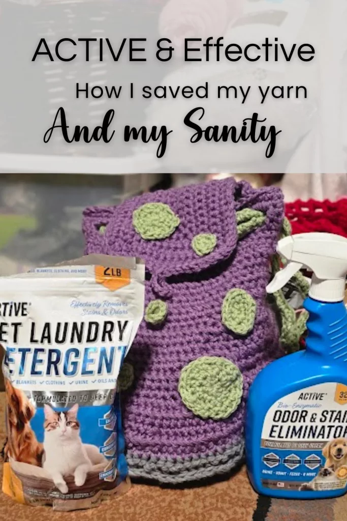 ACTIVE Pet Laundry Detergent and Odor & Stain Eliminator Spray placed on a carpeted floor beside a handmade purple crochet bag with green patches. In the background, baskets of yarn and crafting supplies suggest a cozy, pet-friendly maker space.